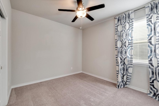 spare room featuring baseboards, carpet, and ceiling fan