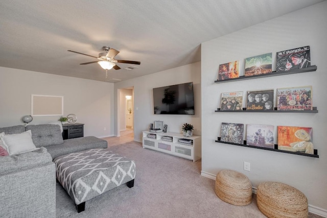 carpeted living room with baseboards and ceiling fan