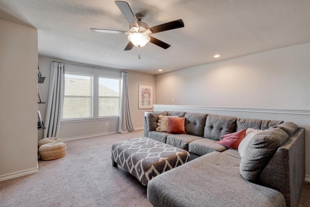 living area featuring baseboards, ceiling fan, light carpet, recessed lighting, and a textured ceiling