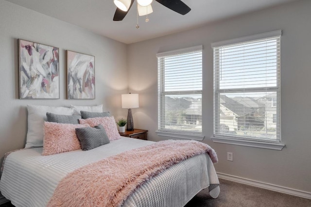 carpeted bedroom featuring ceiling fan and baseboards