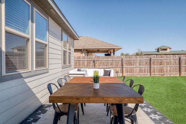 view of patio with outdoor dining area and fence