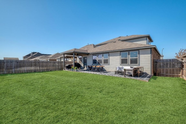 back of house featuring a patio, a yard, and a fenced backyard