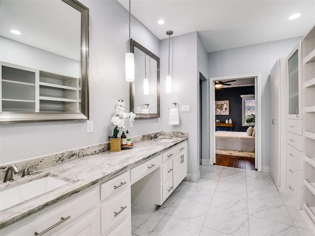 bathroom featuring double vanity, marble finish floor, ensuite bathroom, and a sink