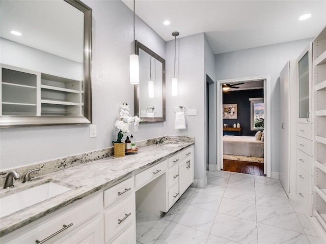 5603 Oakwood Cv Unit 232, Austin, TX 78731 - ensuite bathroom featuring double vanity, marble finish flooring, ceiling fan, and recessed lighting