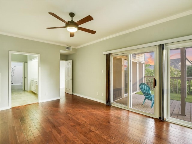 unfurnished bedroom with dark wood-type flooring, access to outside, crown molding, and visible vents