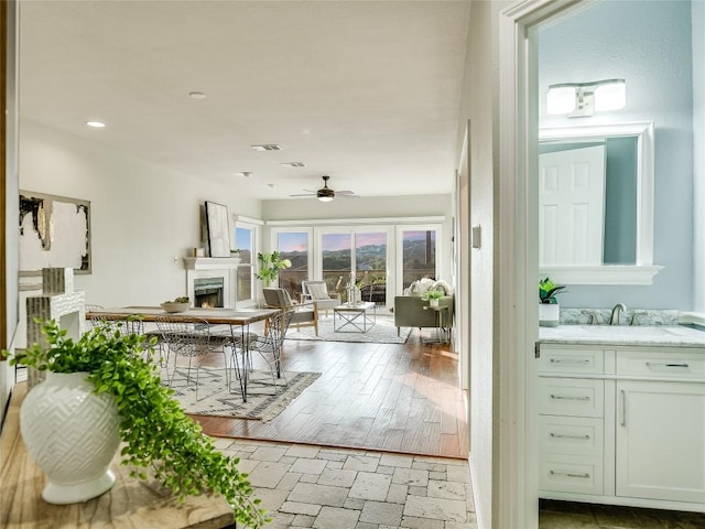 5603 Oakwood Cv Unit 232, Austin, TX 78731 - living area featuring ceiling fan and a warm lit fireplace