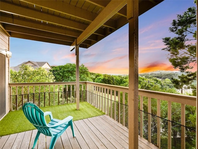 wooden terrace featuring a lawn