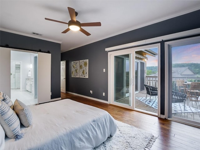 bedroom featuring connected bathroom, crown molding, baseboards, hardwood / wood-style flooring, and access to outside