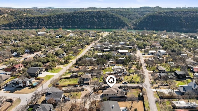 drone / aerial view with a wooded view and a residential view