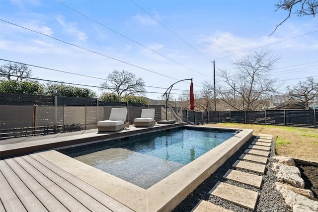 view of pool featuring a fenced in pool, a wooden deck, and a fenced backyard