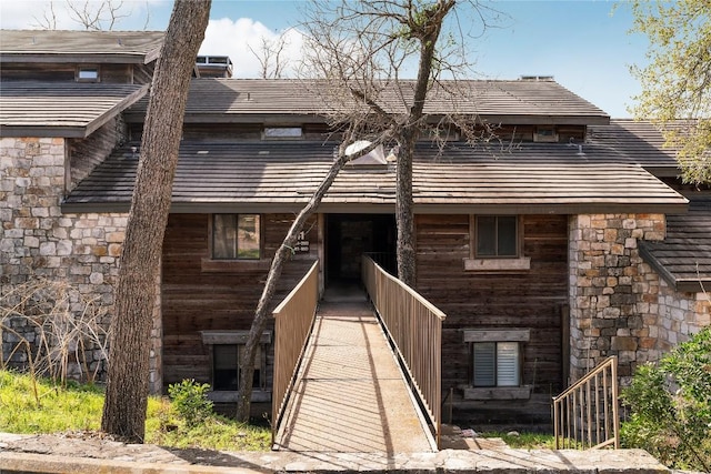 exterior space featuring stone siding