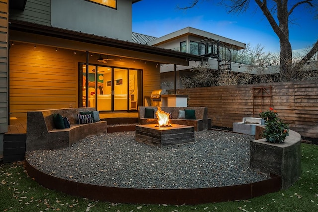 view of patio / terrace with grilling area, fence, and an outdoor fire pit