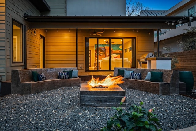 view of patio featuring an outdoor living space with a fire pit and a grill