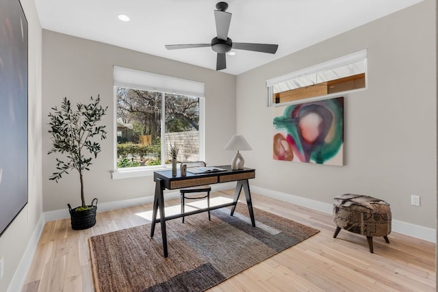 office featuring a ceiling fan, recessed lighting, baseboards, and light wood-type flooring