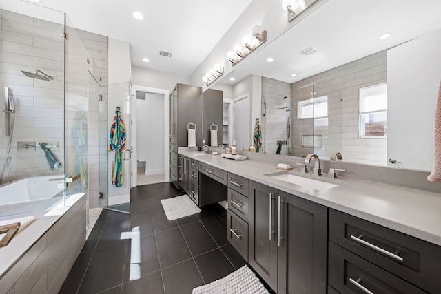 bathroom featuring a shower stall, tile patterned floors, and a sink