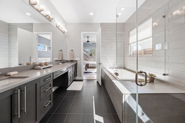 bathroom featuring tile patterned flooring, plenty of natural light, a ceiling fan, and a sink