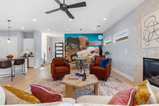 living area with light wood finished floors, visible vents, recessed lighting, and a ceiling fan