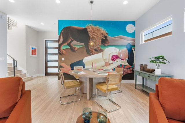 dining room with recessed lighting, baseboards, wood finished floors, and stairs