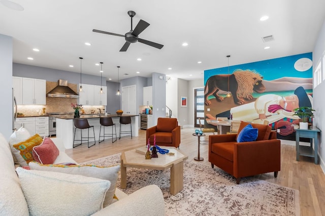 living room with visible vents, recessed lighting, light wood-type flooring, and ceiling fan