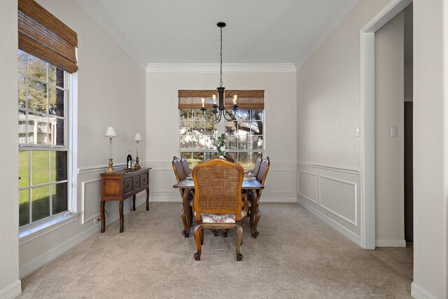 dining space featuring plenty of natural light, a chandelier, carpet flooring, and crown molding