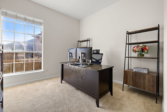 home office with baseboards and light carpet