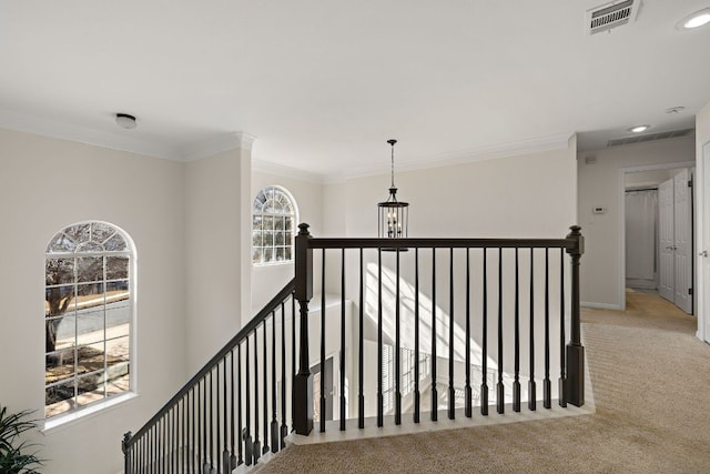 stairway featuring carpet, visible vents, baseboards, an inviting chandelier, and crown molding