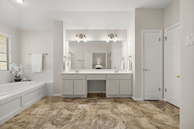 full bathroom featuring a bath, a sink, walk in shower, and double vanity