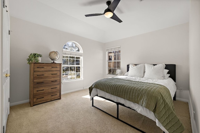 bedroom featuring light carpet, ceiling fan, lofted ceiling, and baseboards