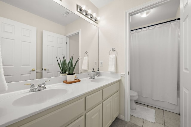 full bathroom with tile patterned flooring, double vanity, toilet, and a sink