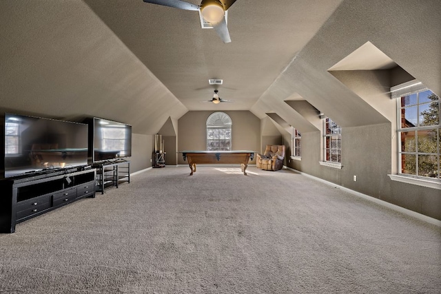 rec room featuring visible vents, ceiling fan, lofted ceiling, carpet flooring, and a textured ceiling