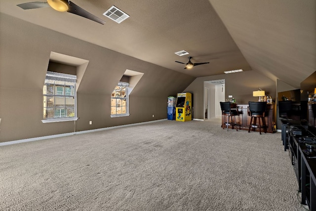 unfurnished office featuring visible vents, ceiling fan, and vaulted ceiling