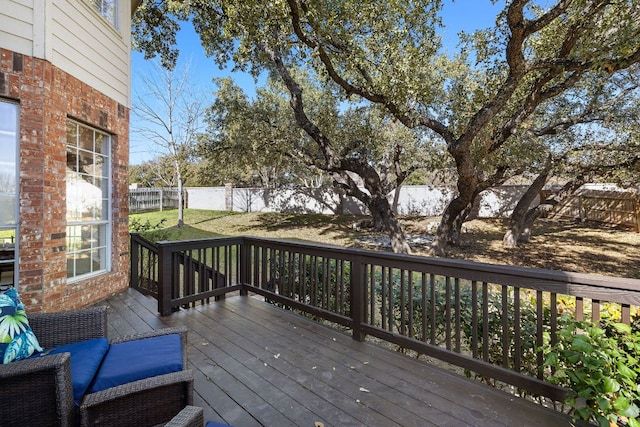 wooden deck with a fenced backyard