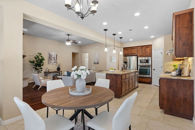 dining room featuring recessed lighting, visible vents, baseboards, and ceiling fan with notable chandelier