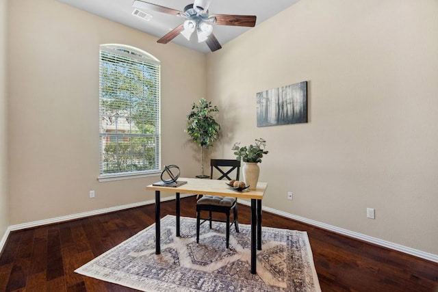 home office featuring visible vents, baseboards, dark wood-type flooring, and a ceiling fan