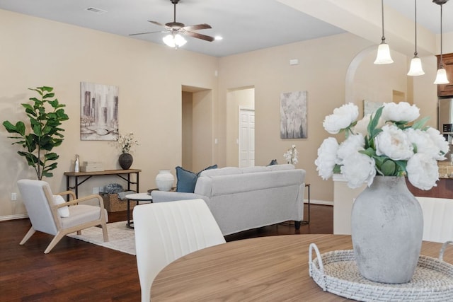 dining area featuring visible vents, baseboards, a ceiling fan, and dark wood-style flooring