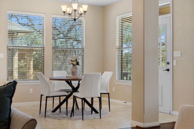 dining area featuring plenty of natural light, a notable chandelier, and light tile patterned flooring