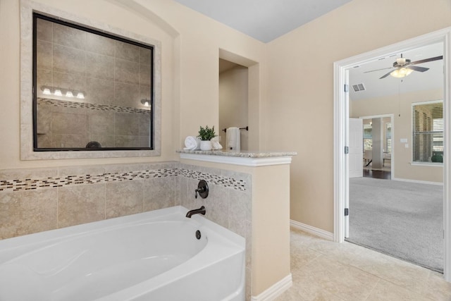 full bath with tile patterned floors, a garden tub, a ceiling fan, connected bathroom, and baseboards