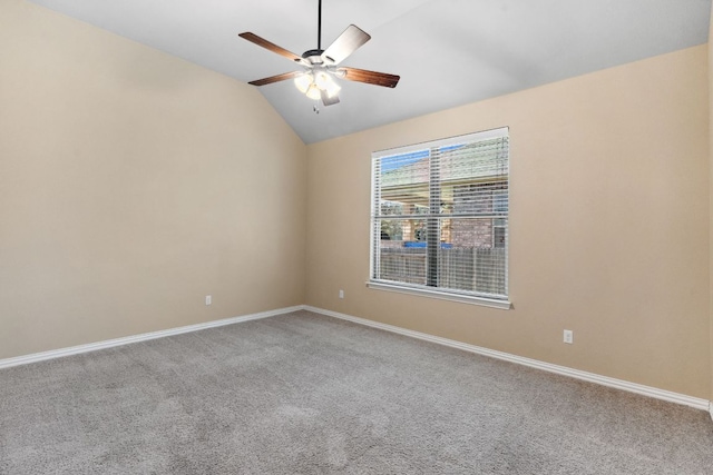 spare room with baseboards, carpet floors, a ceiling fan, and vaulted ceiling