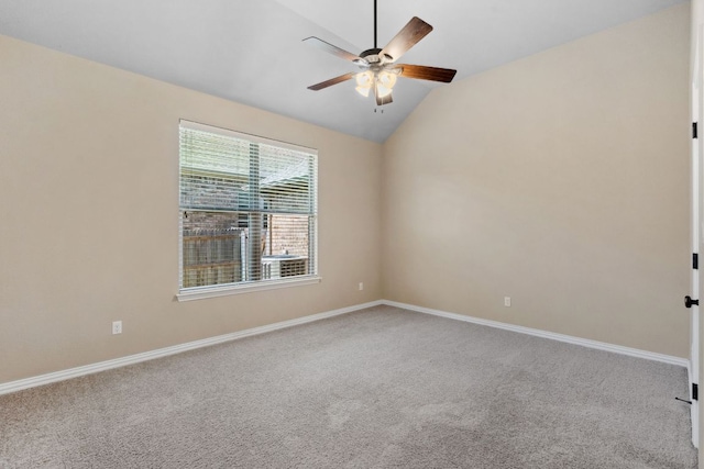 spare room with carpet floors, baseboards, ceiling fan, and vaulted ceiling