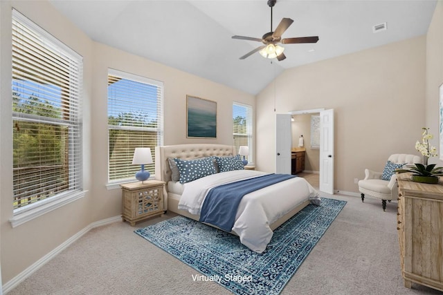 carpeted bedroom featuring visible vents, ensuite bath, baseboards, lofted ceiling, and ceiling fan