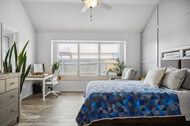 bedroom featuring lofted ceiling, wood finished floors, baseboards, and ceiling fan