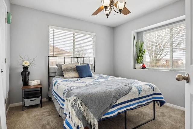 bedroom featuring a ceiling fan, baseboards, and carpet floors