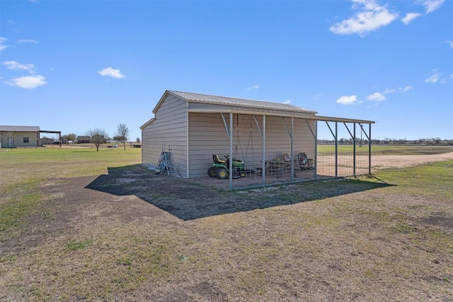 view of pole building with a carport and a yard