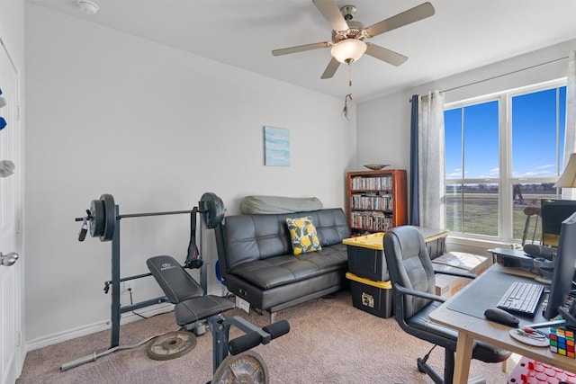 carpeted office with baseboards and ceiling fan