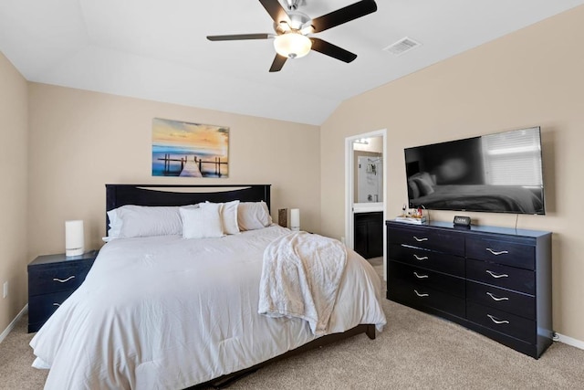 bedroom with visible vents, light colored carpet, baseboards, and vaulted ceiling