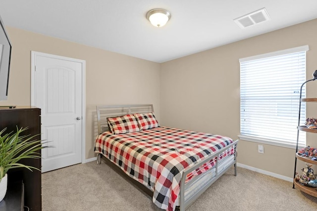 bedroom featuring visible vents, baseboards, and light colored carpet