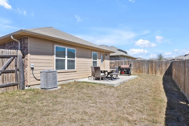 back of property featuring a yard, central air condition unit, a patio, and a fenced backyard