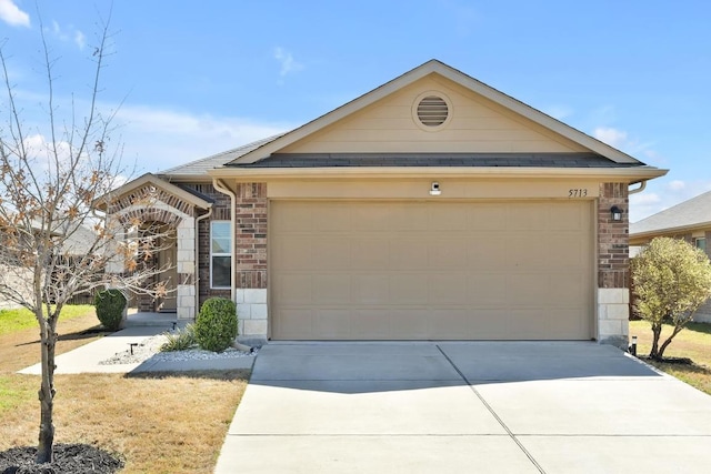 ranch-style home with concrete driveway, a garage, brick siding, and a shingled roof