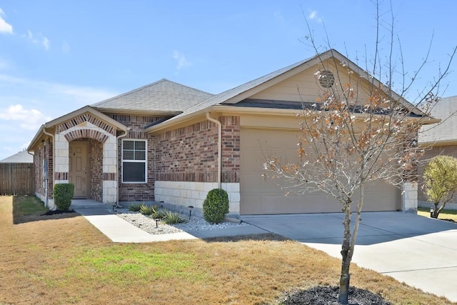 view of front of home with a front lawn, driveway, roof with shingles, a garage, and brick siding