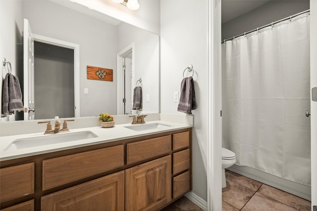 full bathroom with tile patterned flooring, double vanity, toilet, and a sink